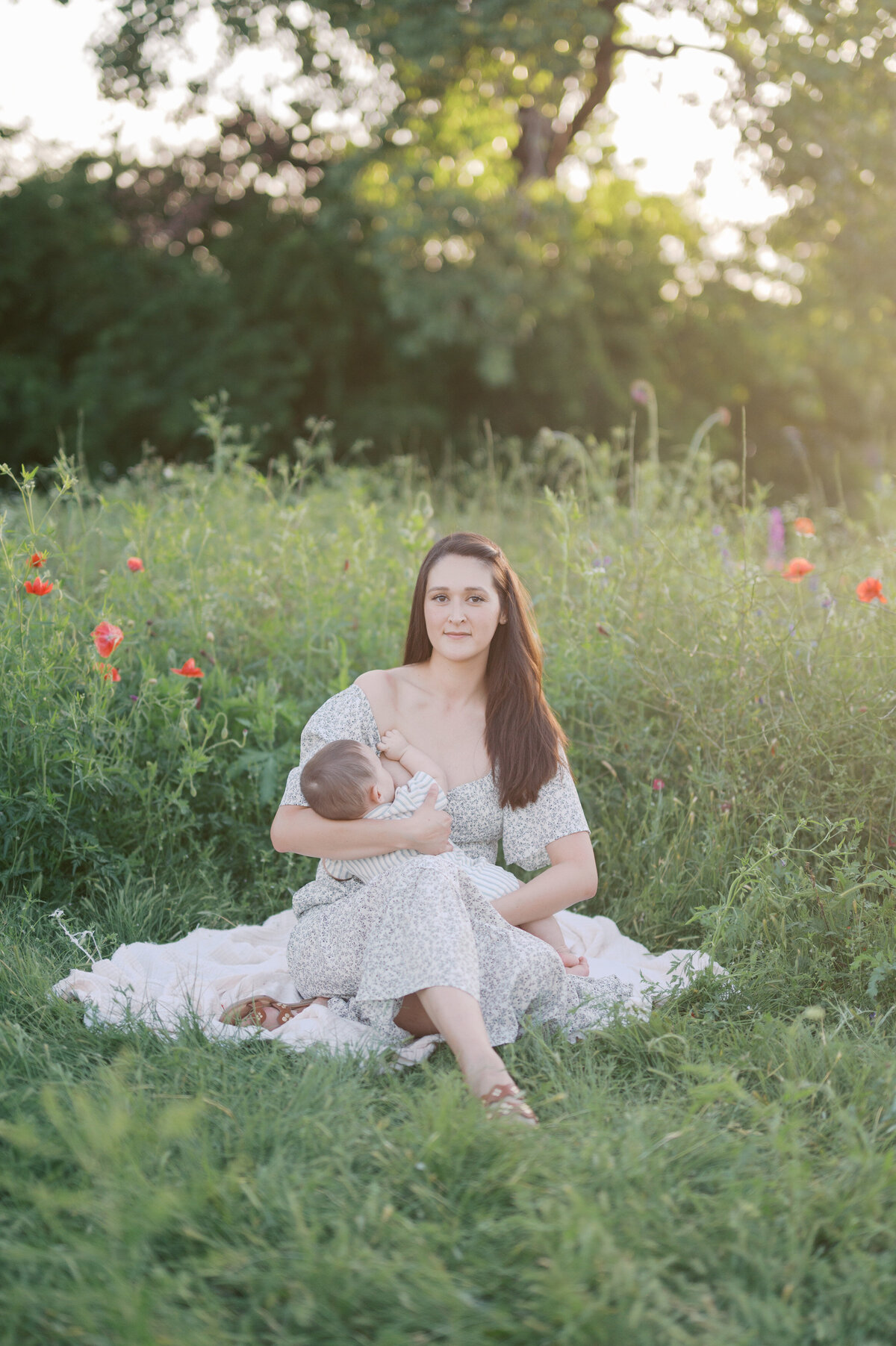 newborn photos of mom and baby in a wildflower field in DFW area