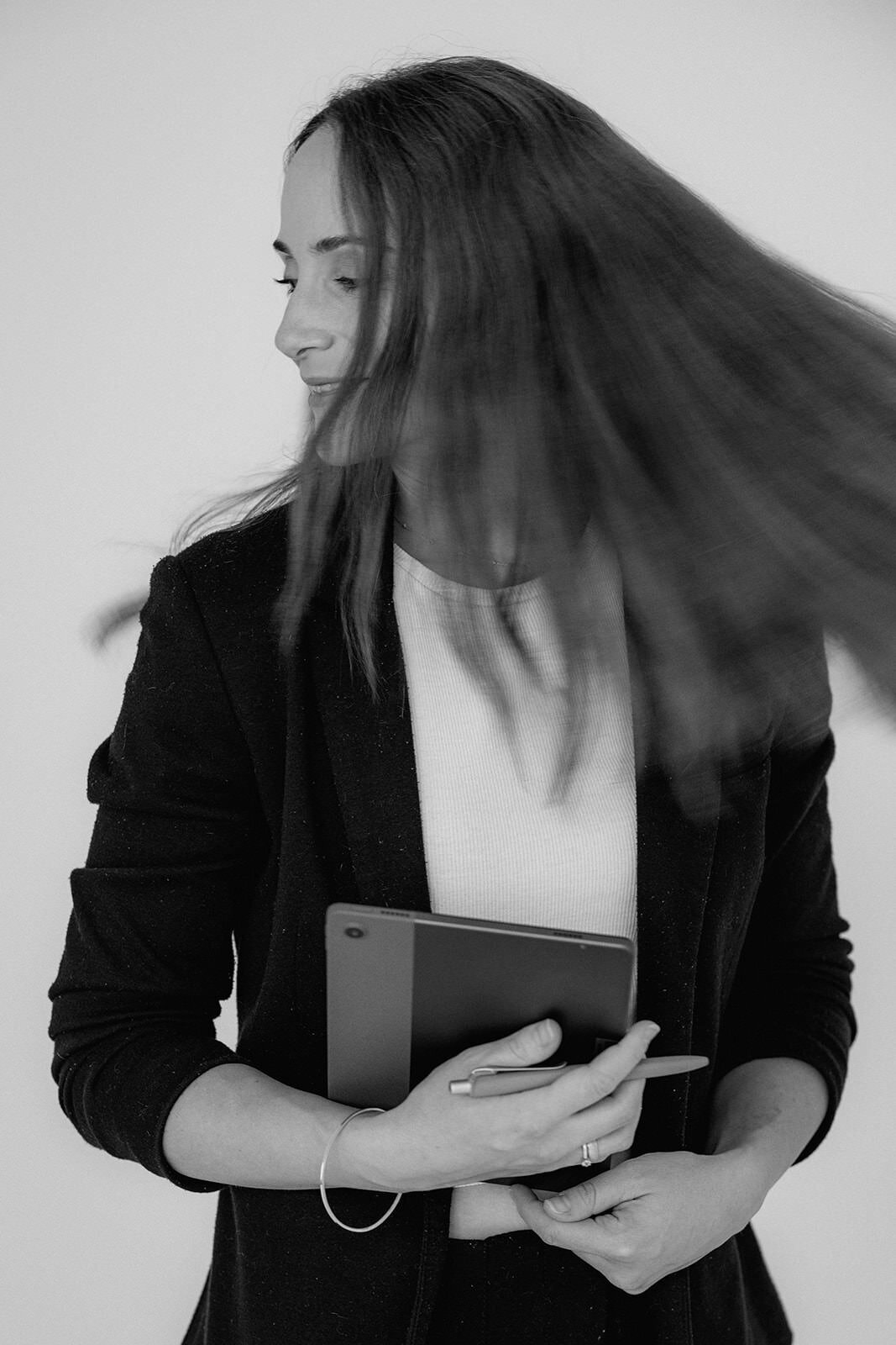 Woman holding a tablet and shaking her head.