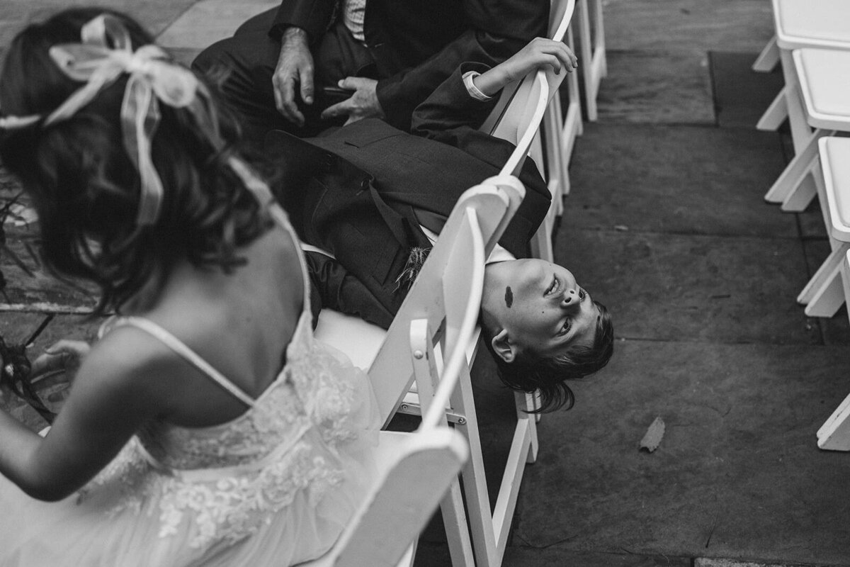 A child hanging off the back of a chair 
