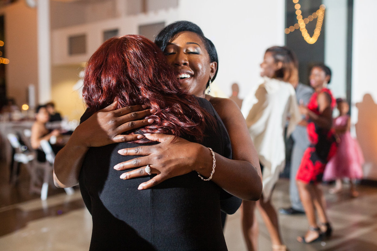 Bride hugs a guest at the end of her wedding reception at the Foundry Art Centre, near St Louis.