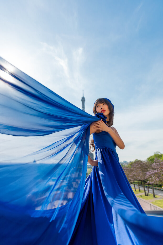 Elegant Paris portrait of Asian woman wearing royal blue princess gown
