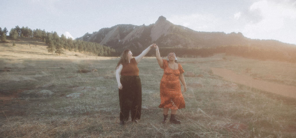 A couple dancing in a field.