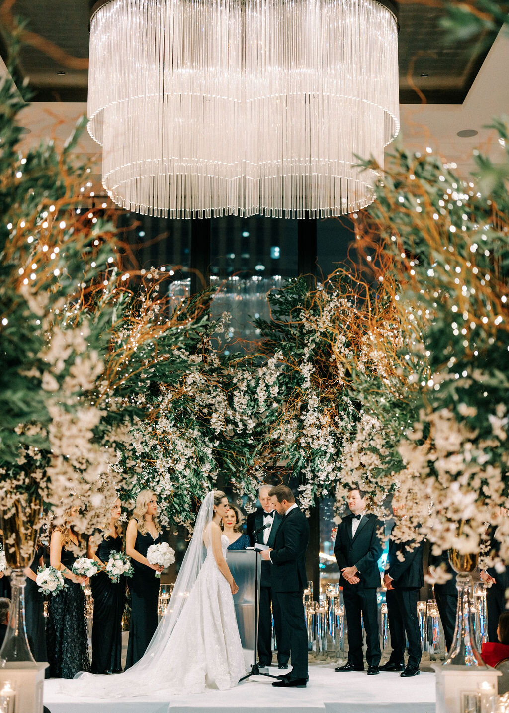 Photo of the bride and groom with the bridal party at the alter. 