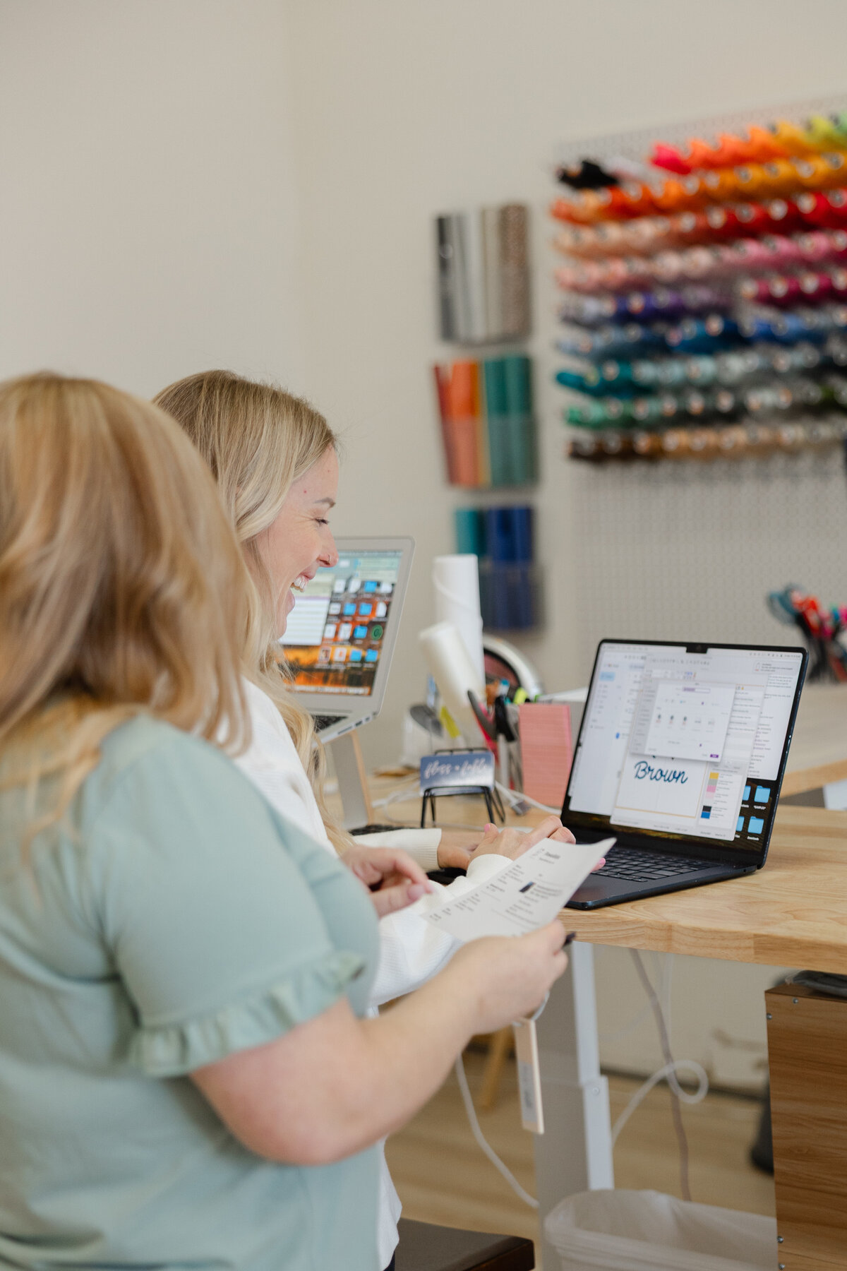 Close-up of sewing tools and embroidery thread spools on a workspace table. Photograph by Yucaipa branding photographer Kaitlyn Dawn Photography.Close-up of sewing tools and embroidery thread spools on a workspace table. Photograph by Yucaipa branding photographer Kaitlyn Dawn Photography.