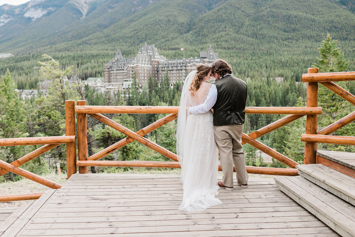 Couple standing on deck in front of the mountains