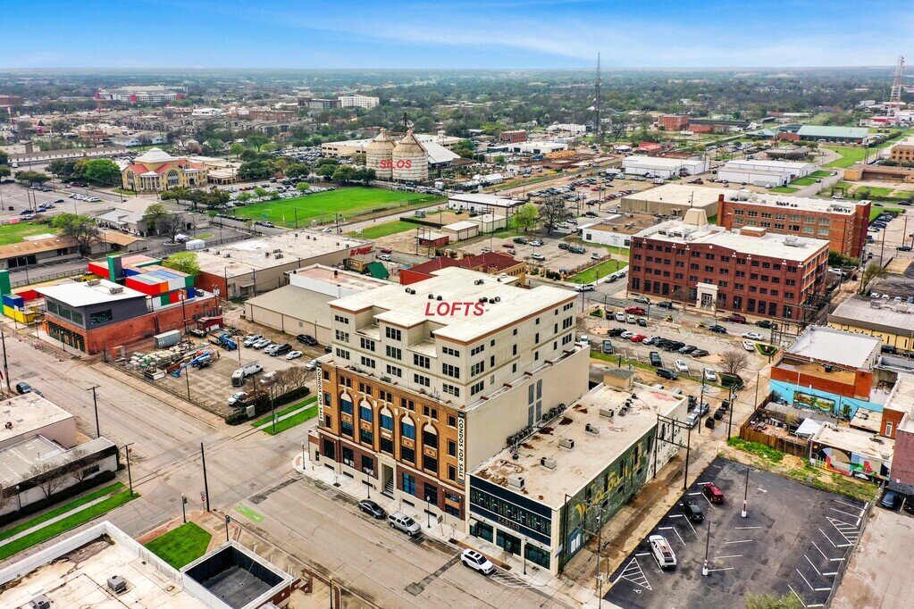 Exterior view of Behrens Lofts and Fabled Bookshop in Downtown Waco, which holds this 2 bedroom, 2.5 bathroom luxury vacation rental loft condo for 8 guests with incredible downtown views, free parking, free wifi and professional decor in downtown Waco, TX.