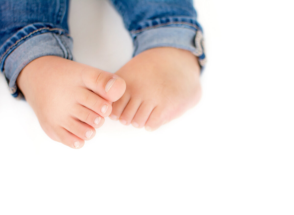 Litte toddler feet and ankles in jeans