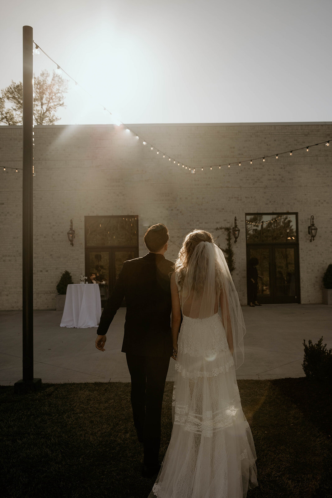 bride and groom at sunset in boho wedding dress