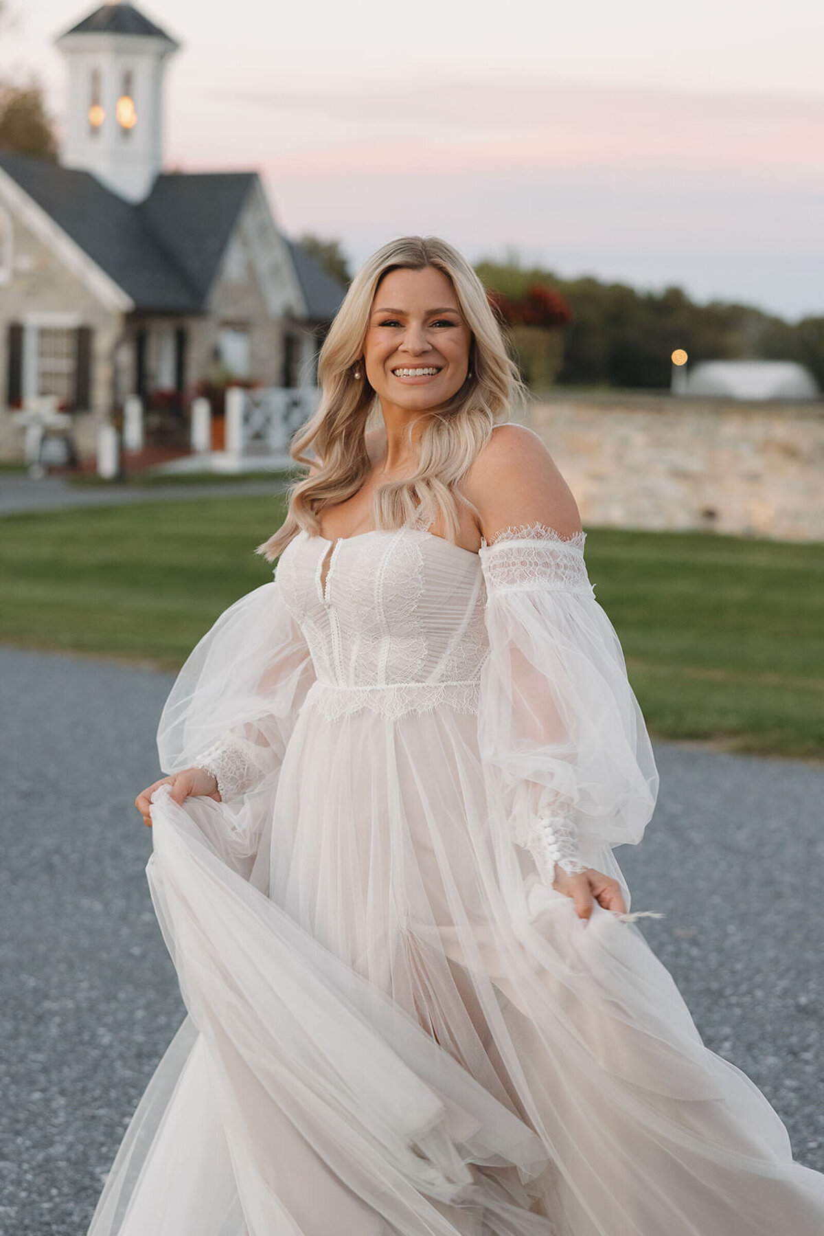 Bride twirling her dress at sunset