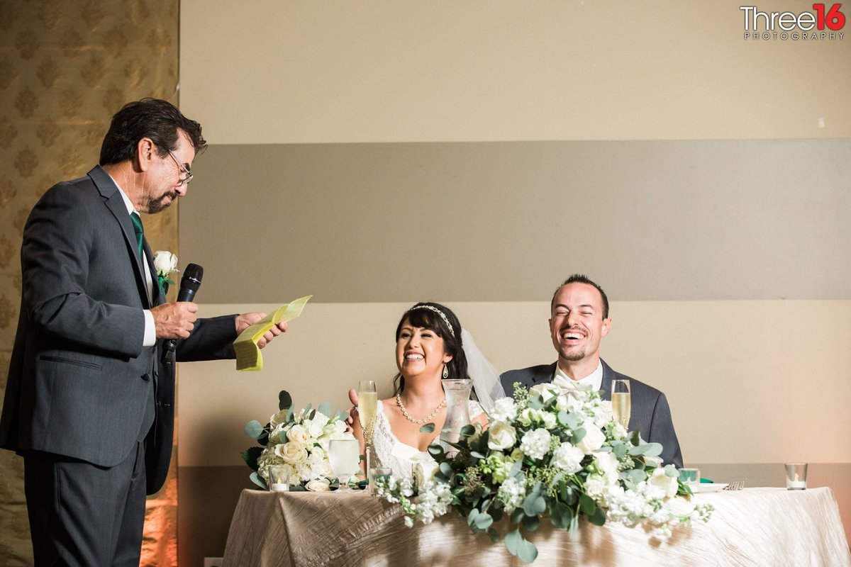 Bride and Groom laugh during a toast