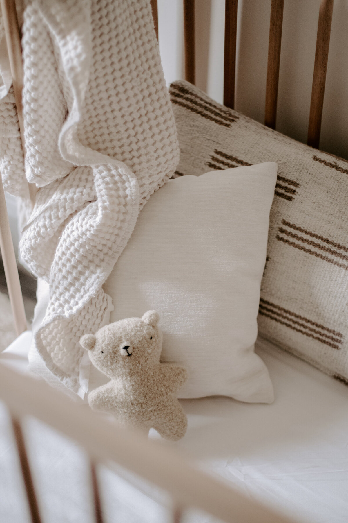 Pillows and cotton blanket in crib