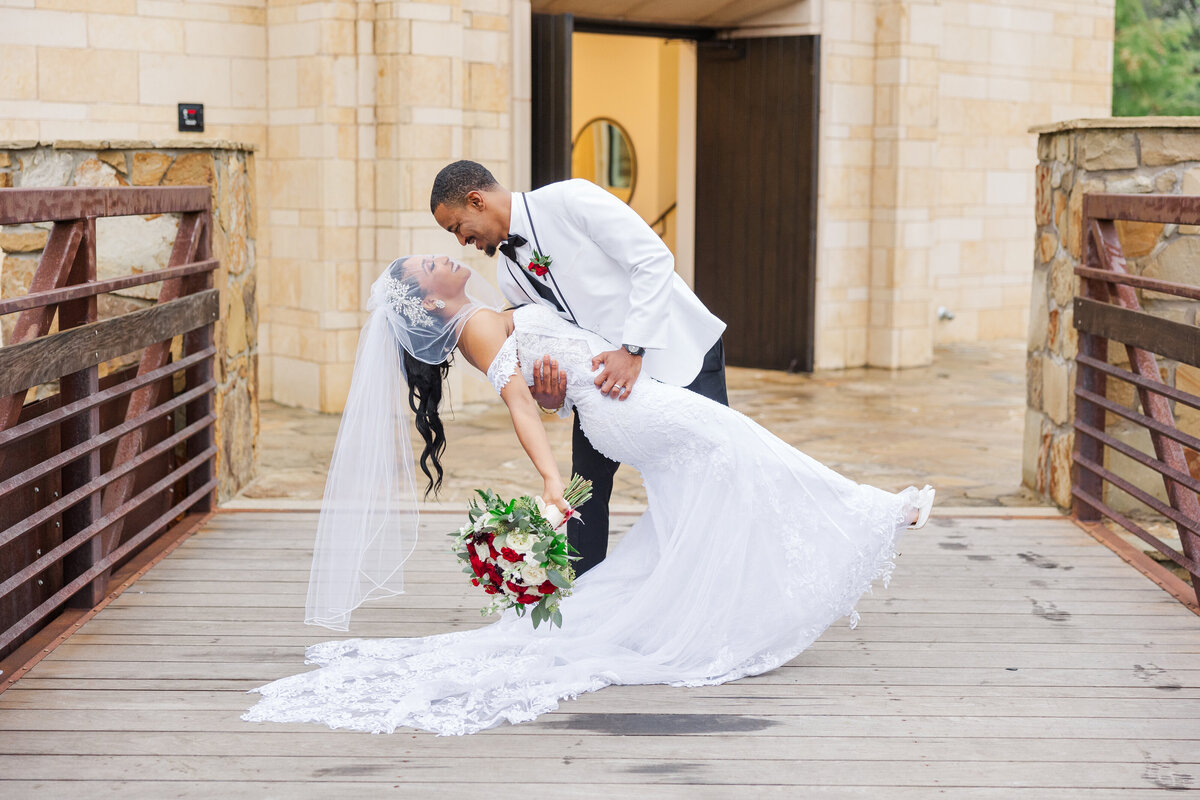 TGroom-dips-bride-on-the-bridge-in-front-of-the-chapel