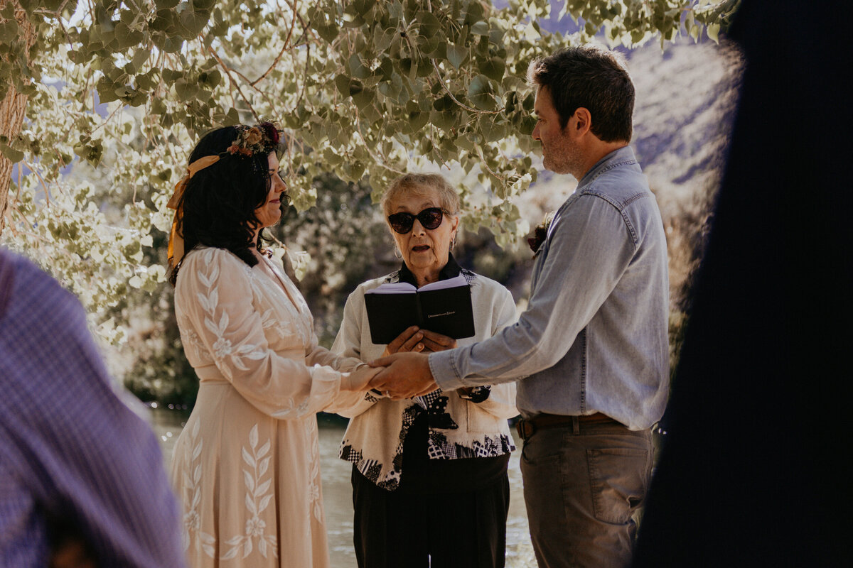 couple exchanging rings during intimate wedding ceremony