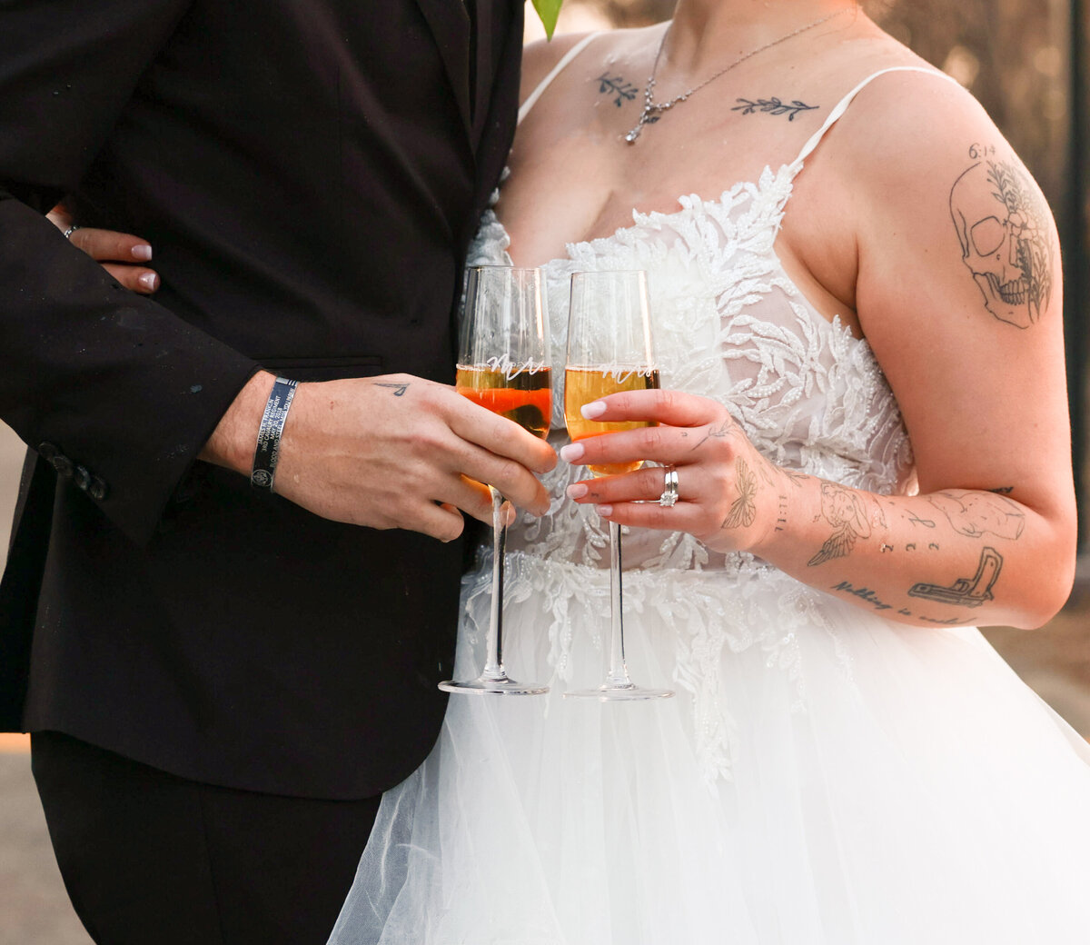 tattoed bride and groom holding champagne glasses celebrating their elopement in Orlando Florida by Orlando elopement photographer Amanda Richardson Photography