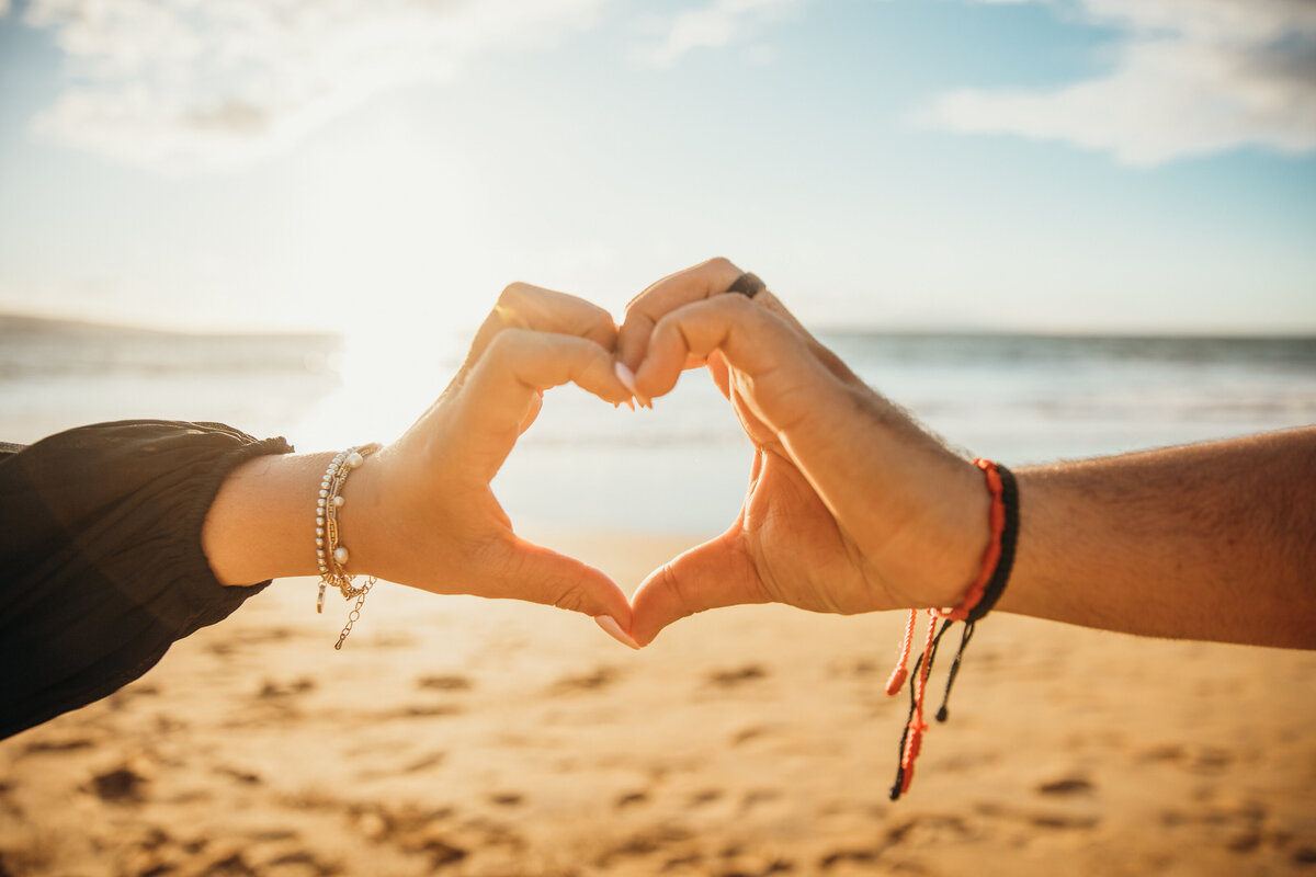 Hawaii Engagement Photographer captures couple making heart with hands