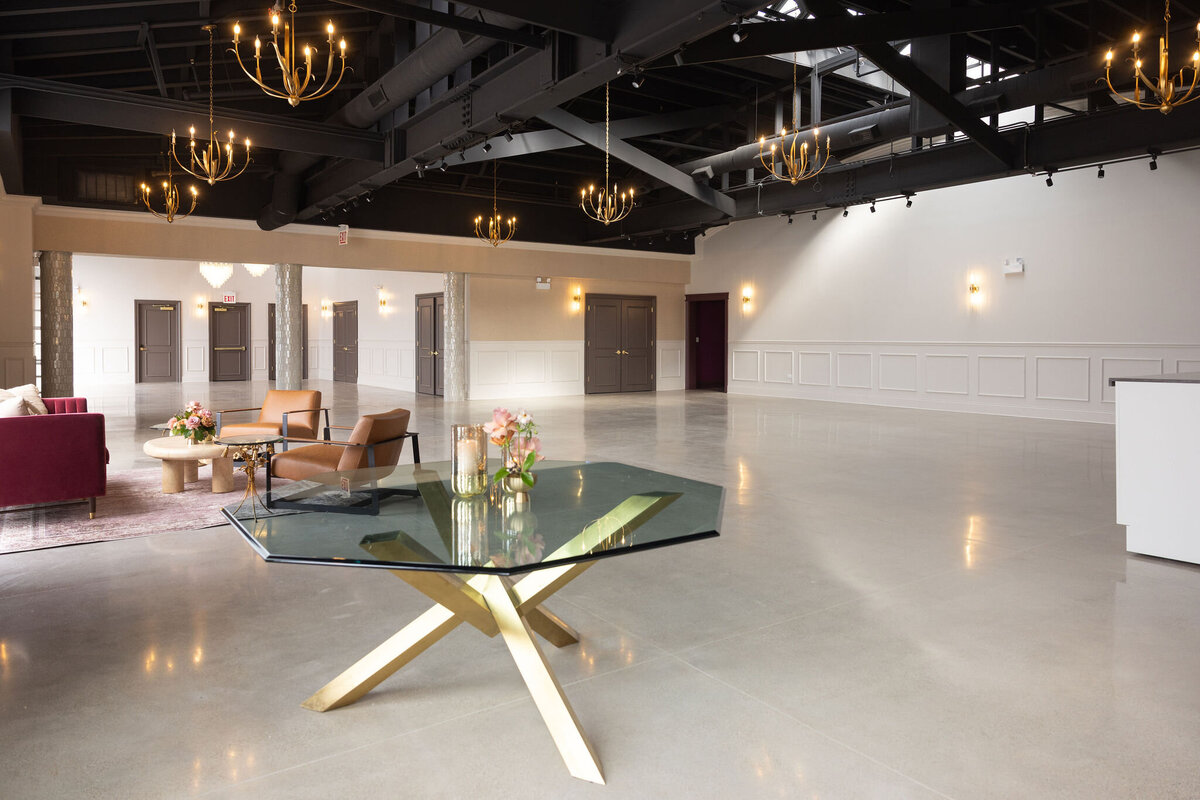 Happy Hour space entrance, elegant and timeless welcome table, large blank slate space with natural lighting and purposeful detail throughout