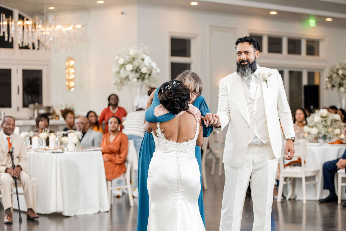 The groom gracefully guides the bride during their first dance as husband and wife.