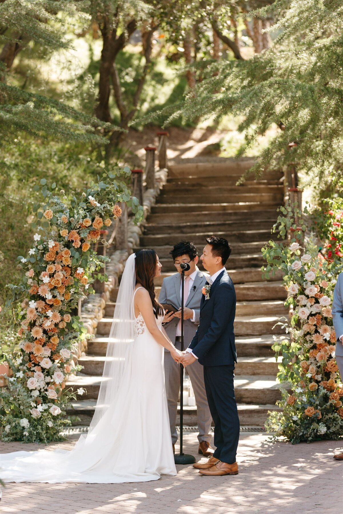 Rancho Las Lomas wedding ceremony couple standing in between two floral pillars