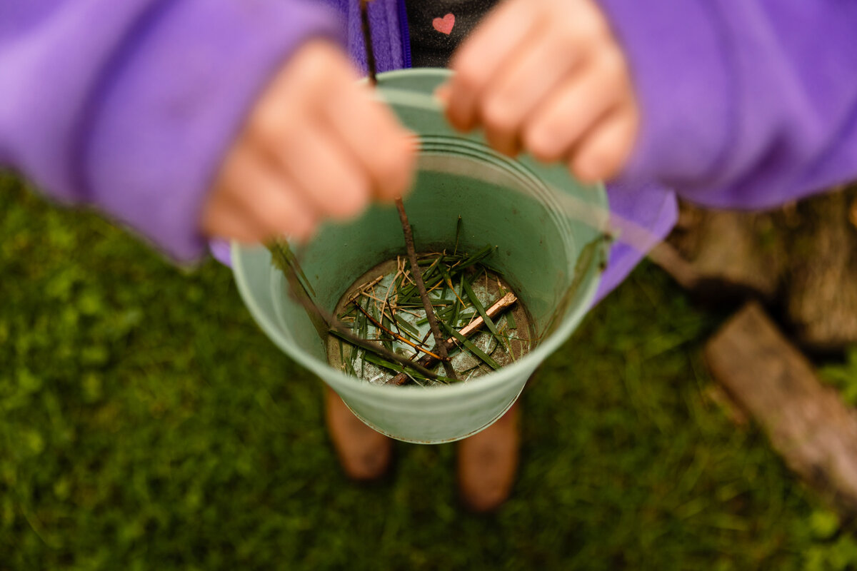 child-holding-stickbug-pail