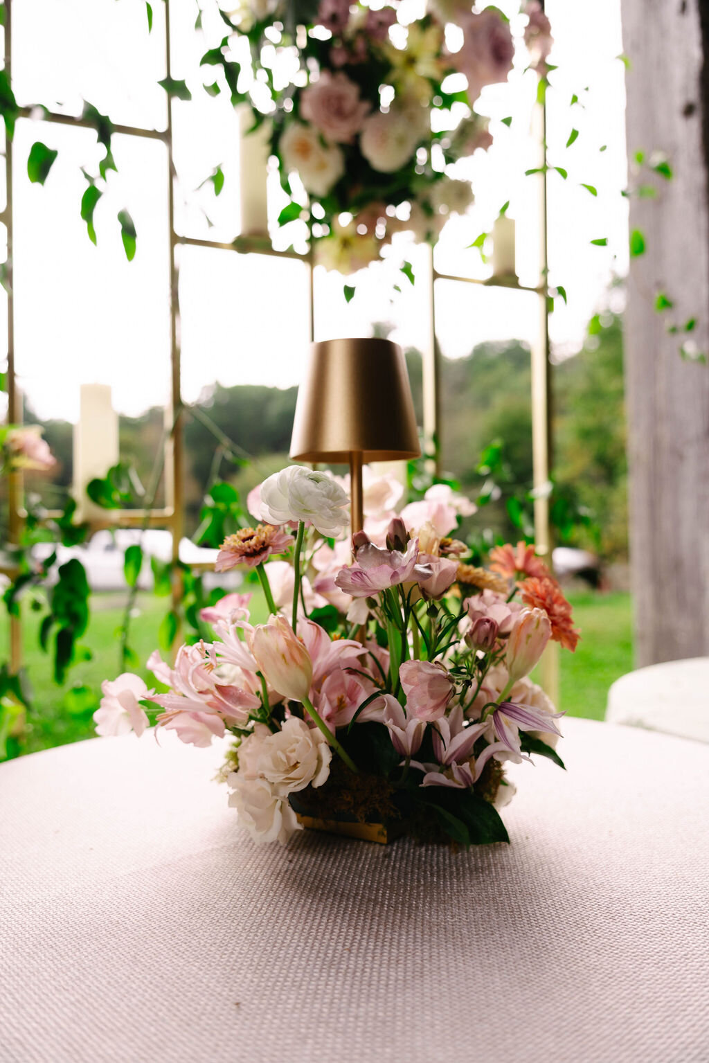 Soft pink and white floral centerpiece under a tented reception design at The Bascom in Highlands, NC.