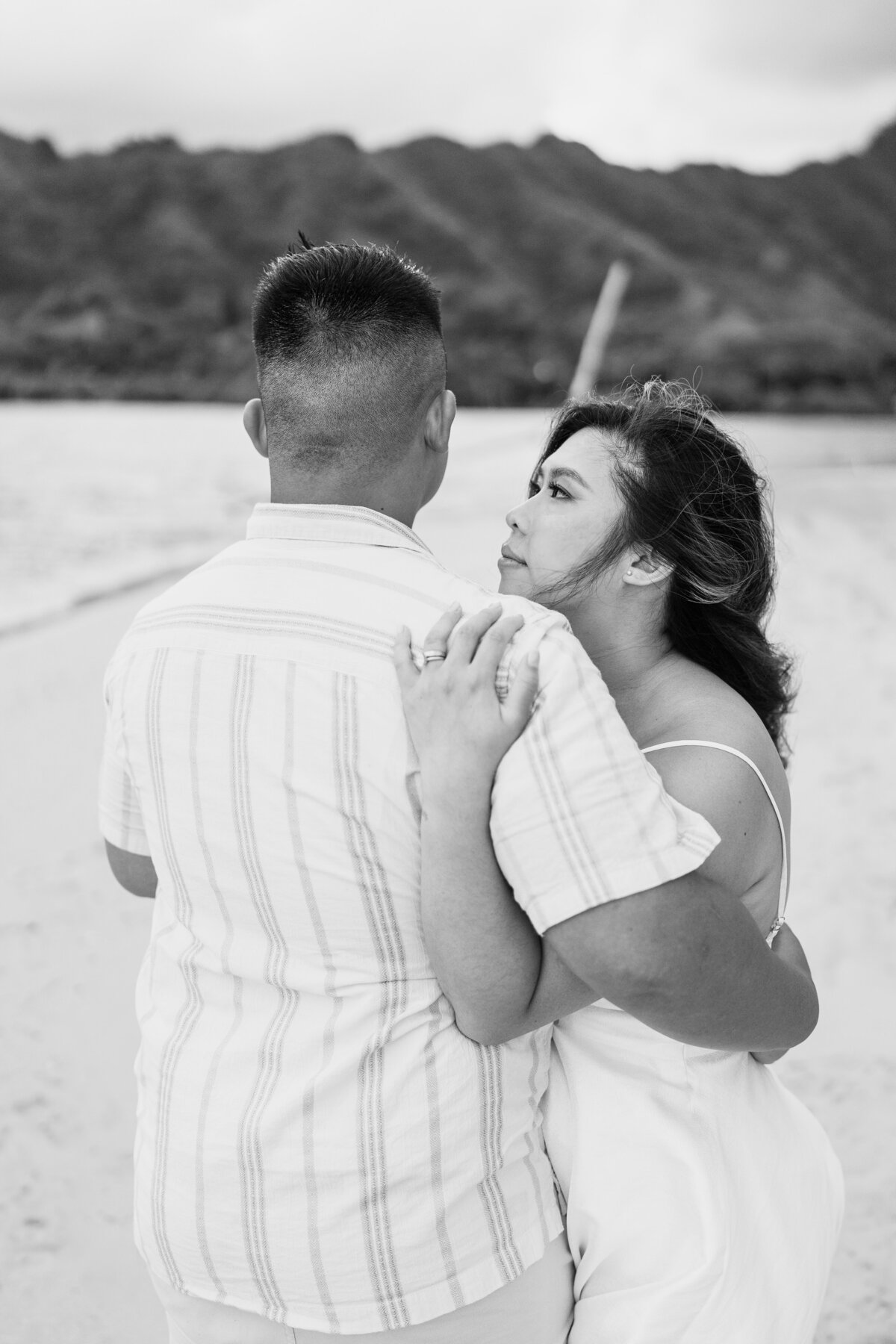 Oahu Hawaii Elopement Asian couple at Secret Island Beach embracing in black and white color.