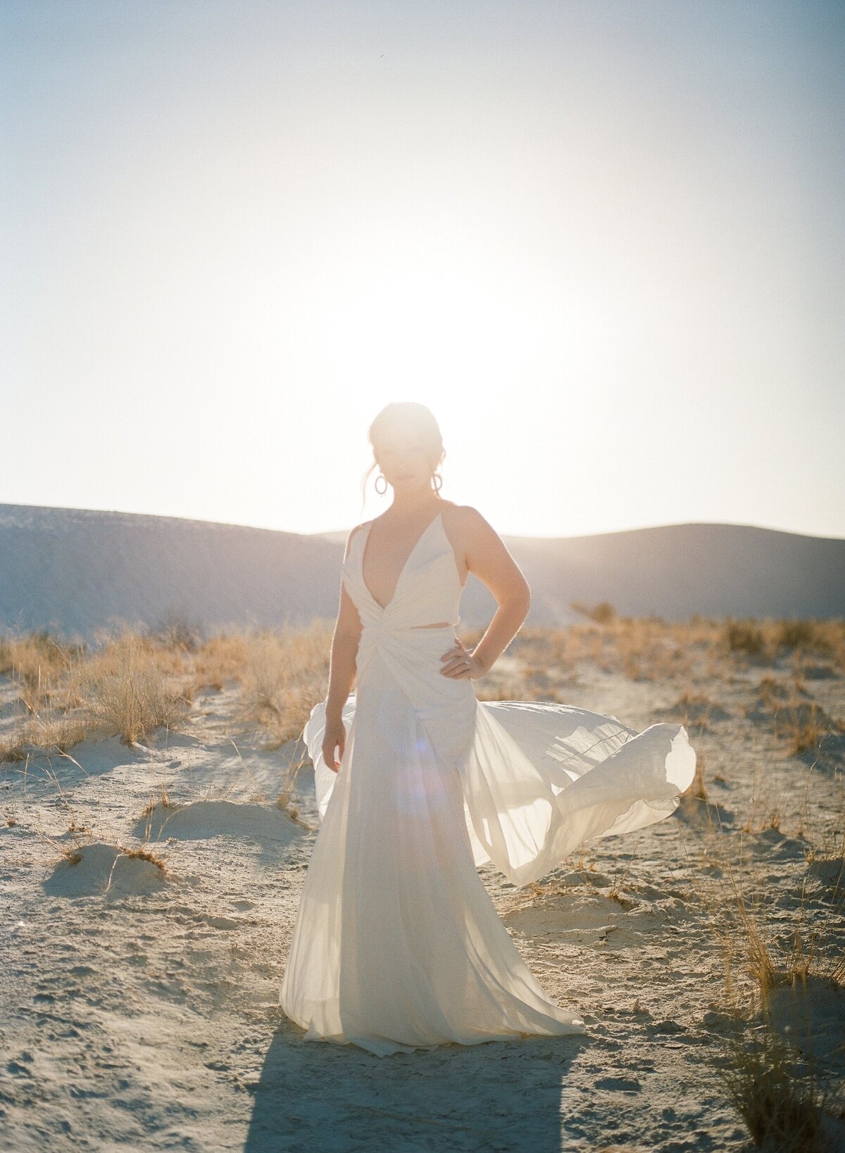 brides wedding dress blowing in white sands new mexico
