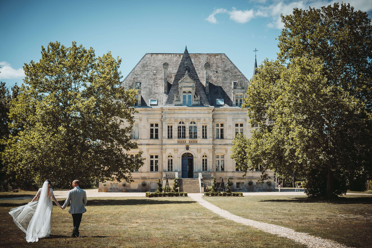 wedding-couple-walking-outside-chateaudelavalouze