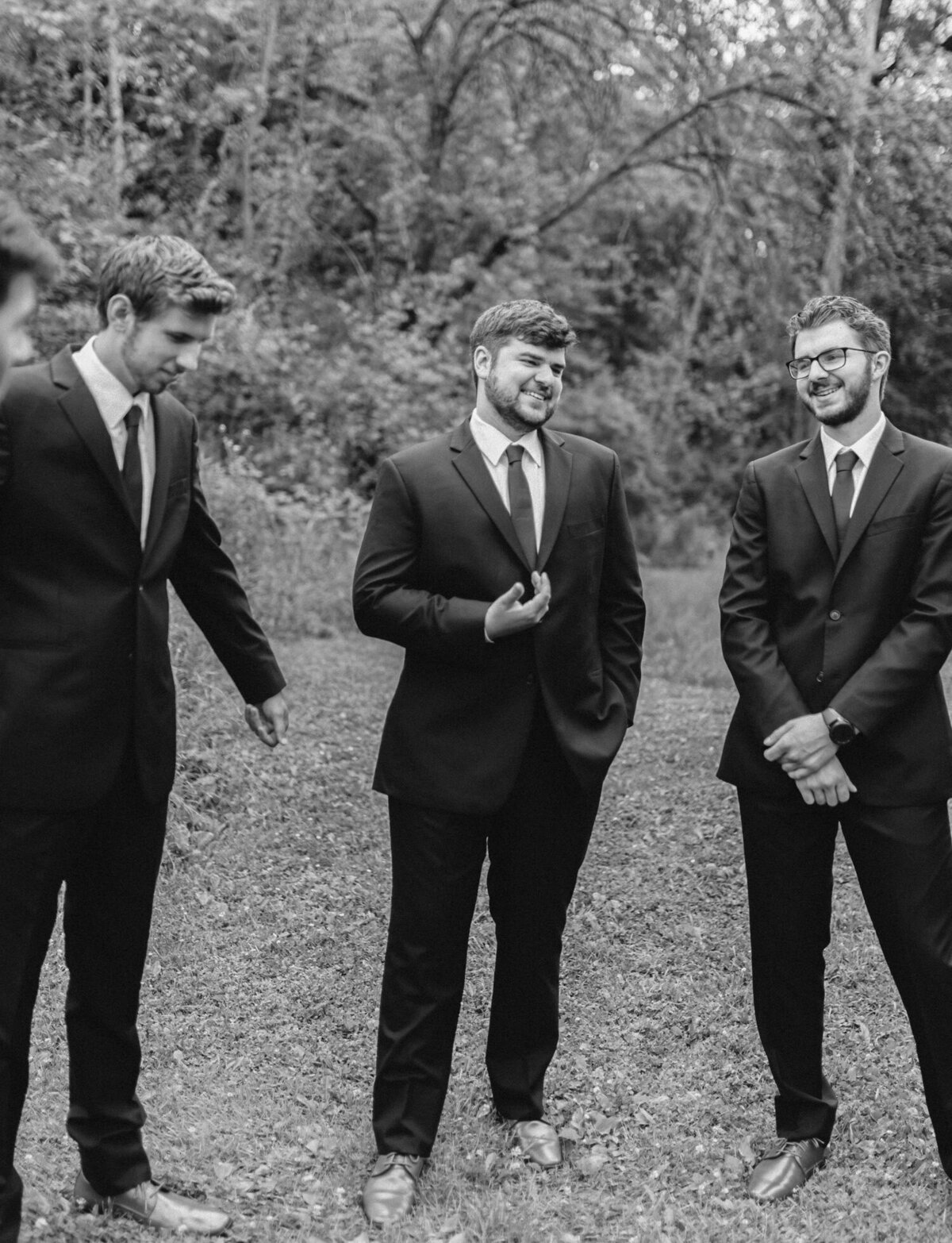 groom and groomsmen laugh, candid film wedding photographer Christina Harrison