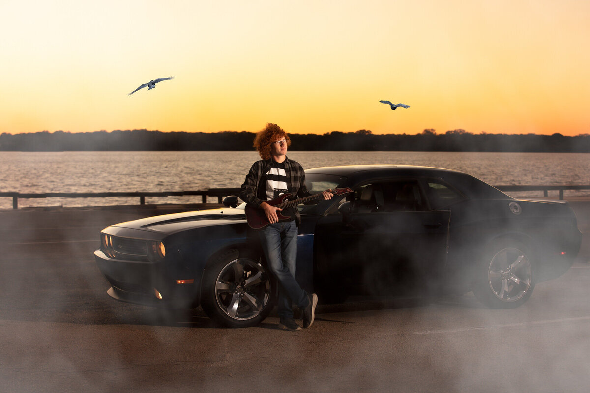 senior-boy-standing-by-car-in-sunset-with-birds