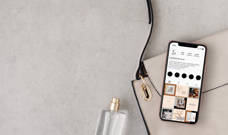 instagram design on iphone with purse and perfume on table