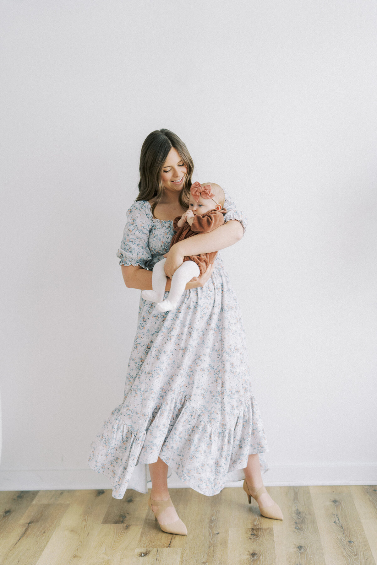 mom rocking baby during studio family session