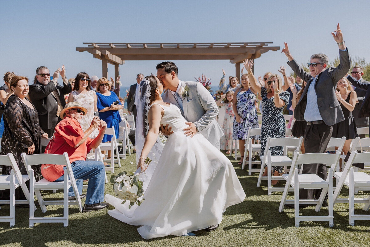 terranea resort wedding ceremony, flower columns, catalina point, first dip kiss.