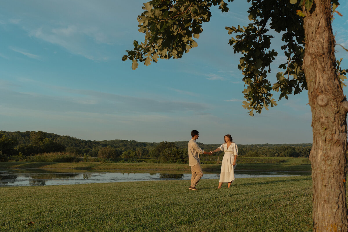 Sunlit picnic moment during a couples session in a vibrant tropical winery setting

