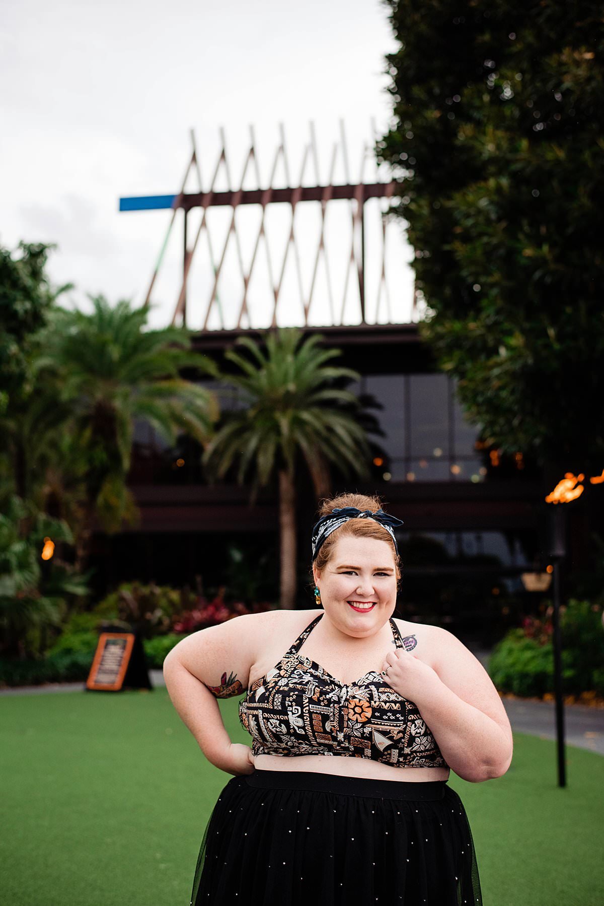 Disney social influencer, the Girl with the Dolewhip Tattoo wearing a black tule skirt and Disney inspired halter outside of the Polynesian Resort at Disney World