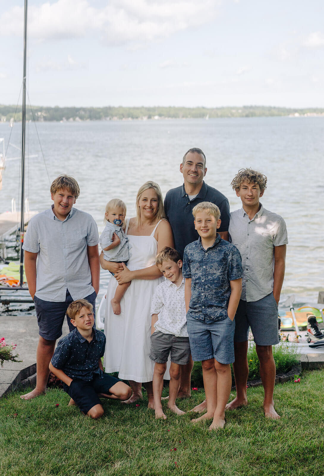 Family standing in front of a lake at generational photoshoot in Finger Lakes, NY