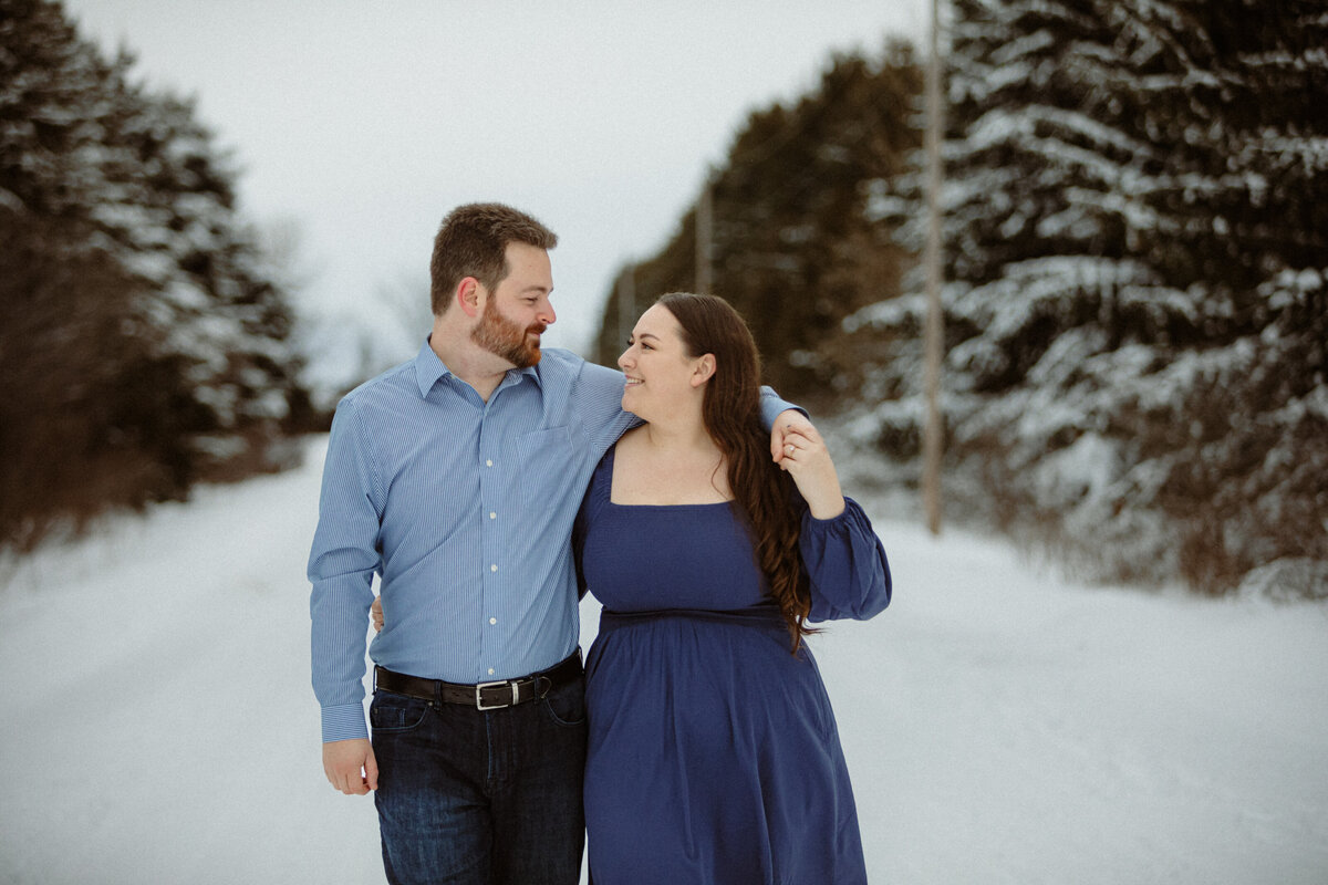 engaged-couple-walking-in-the-snow-in-north-dundas-ottawa-1