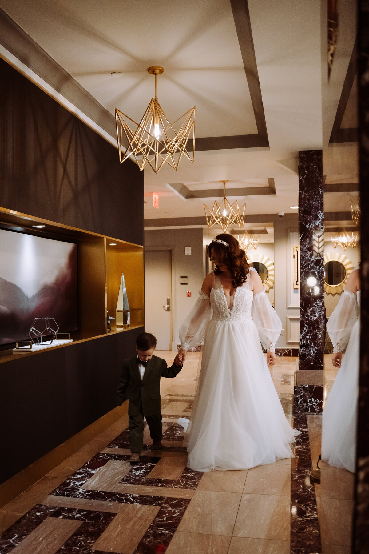 bride holding hands with young child