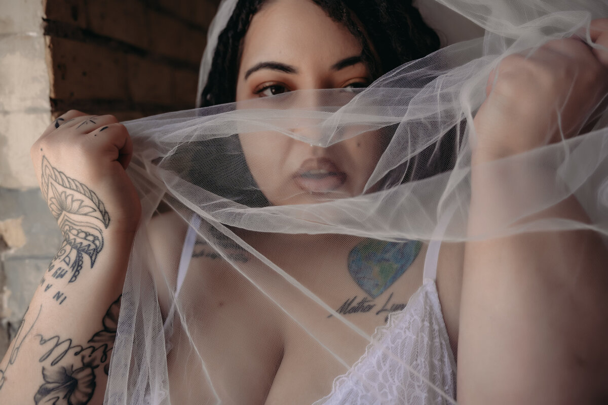 Minnesota boudoir photograph of a bridal boudoir  of a woman holding up a veil close to her face