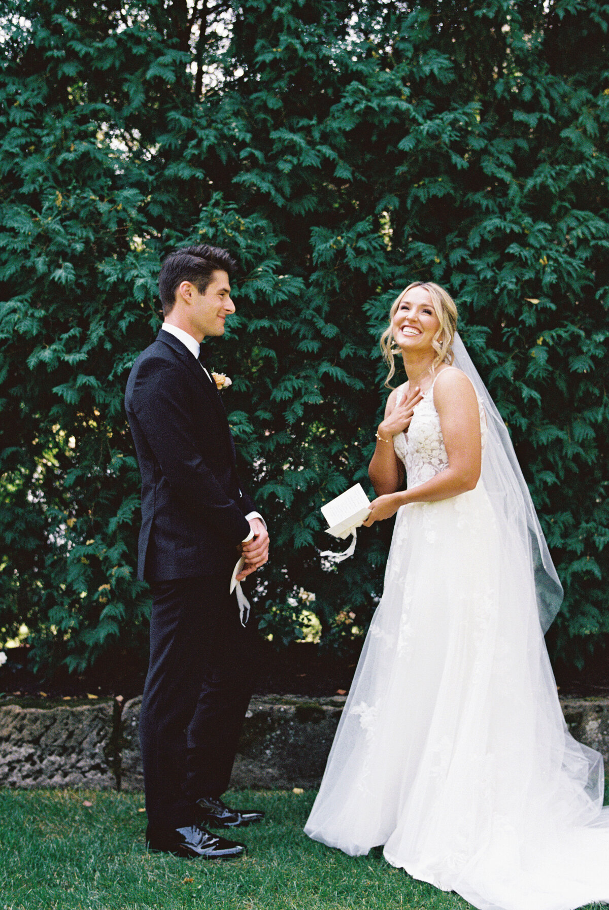 Emotional first look as bride reads a letter to the groom at their Tuscan-inspired Gervasi Vineyard wedding.
