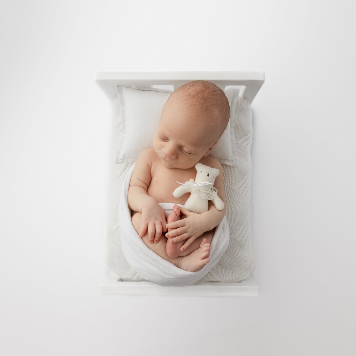 Image is of a newborn baby in a newborn photography prop bed - this bed is hand crafted in tasmania by The Little Shed Project.  Image by Lauren Vanier Photography