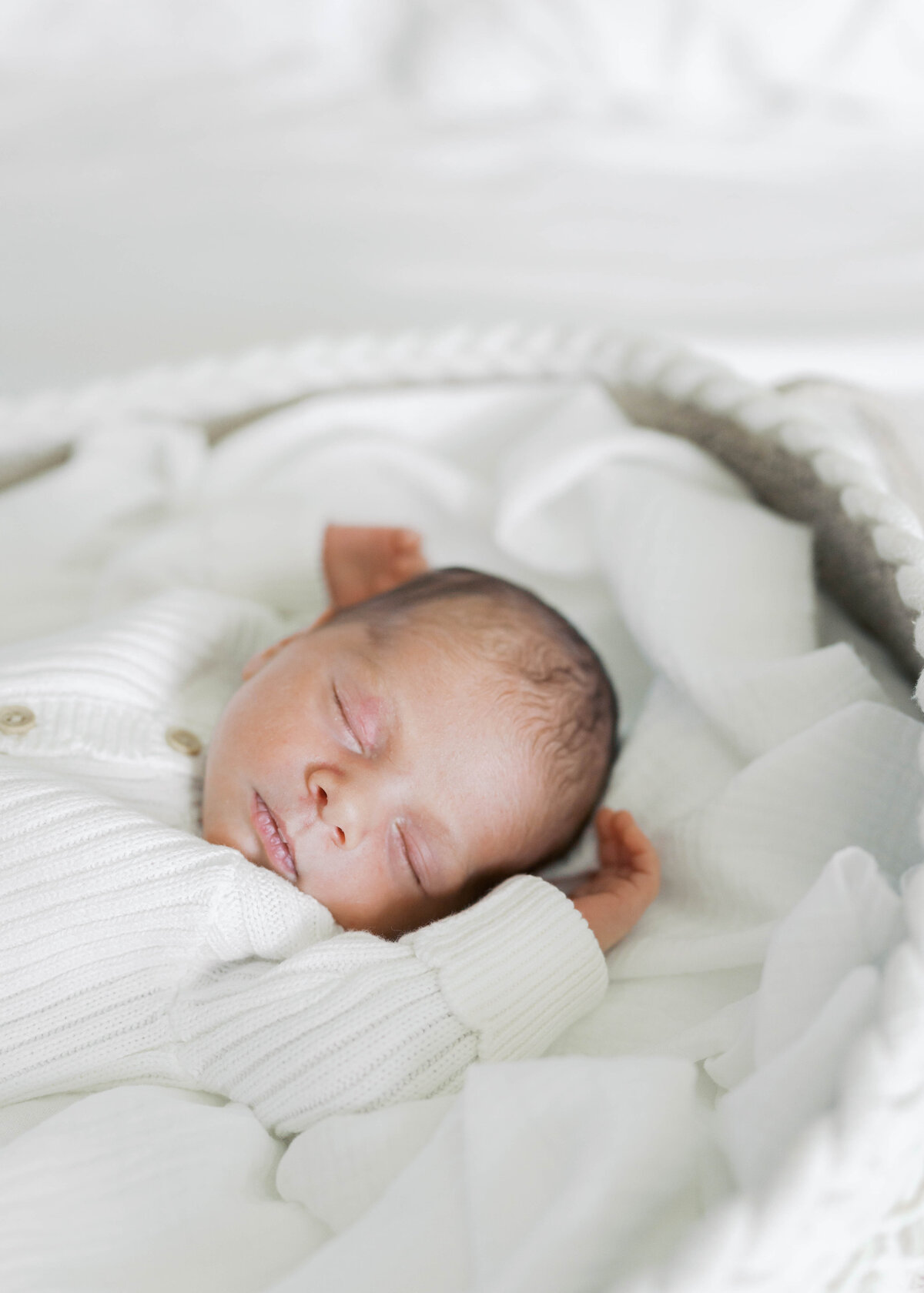 newborn baby sleeping in moses basket in virginia beach newborn session