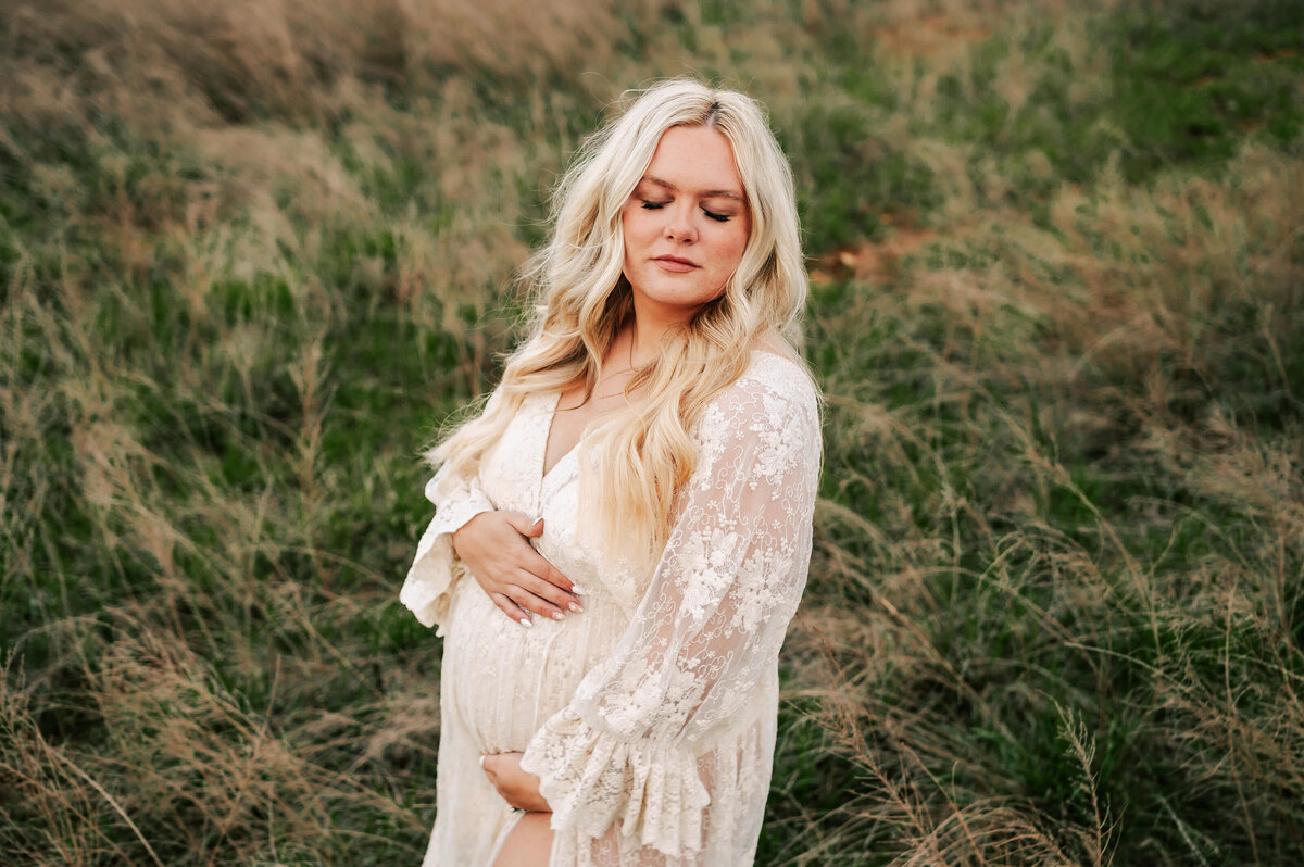 blonde pregnant mom in lace dress in a field in Joplin MO