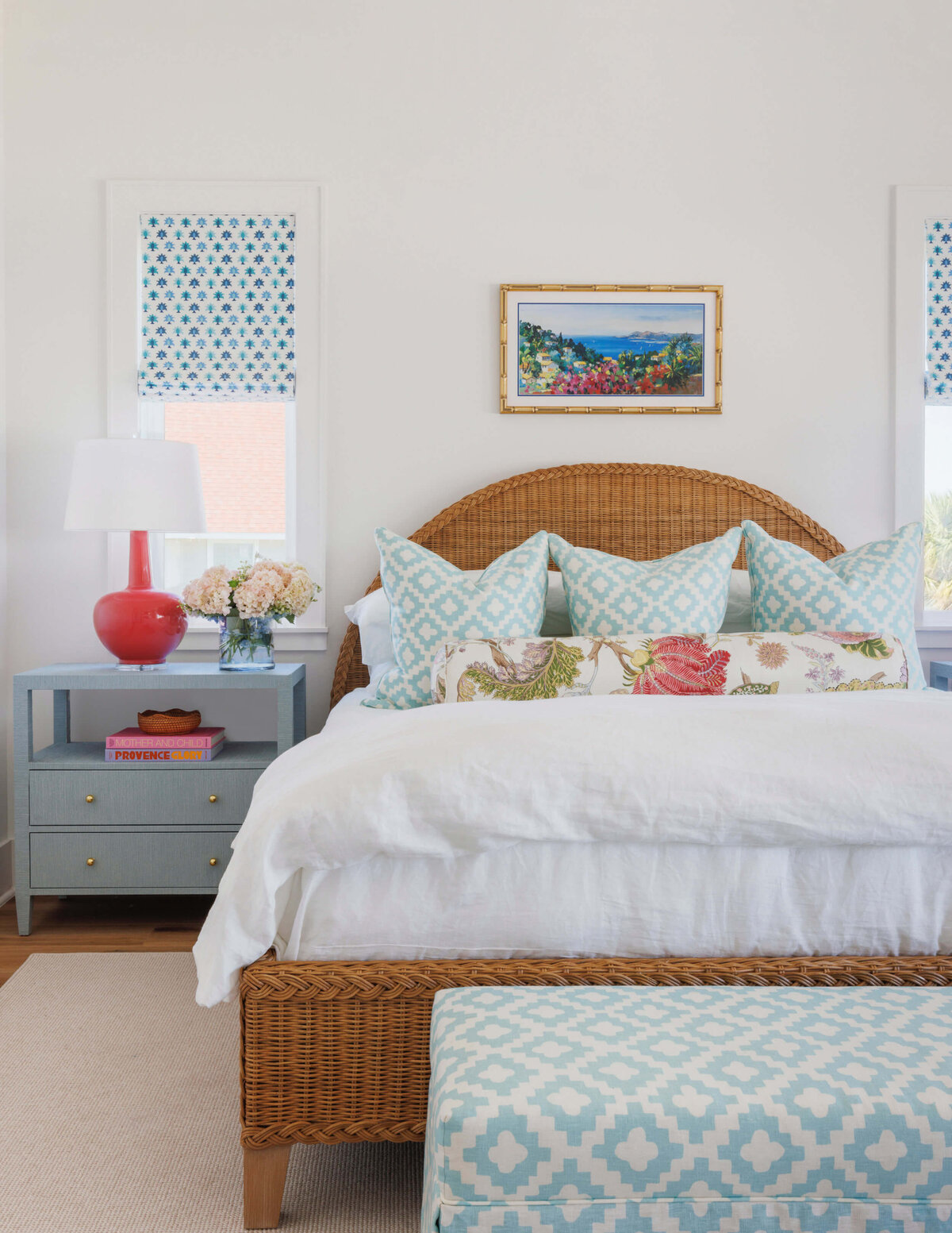 oyster creek studios lighthouse on the lake bedroom with wooden wicker bed frame white bedspread and light blue pillows