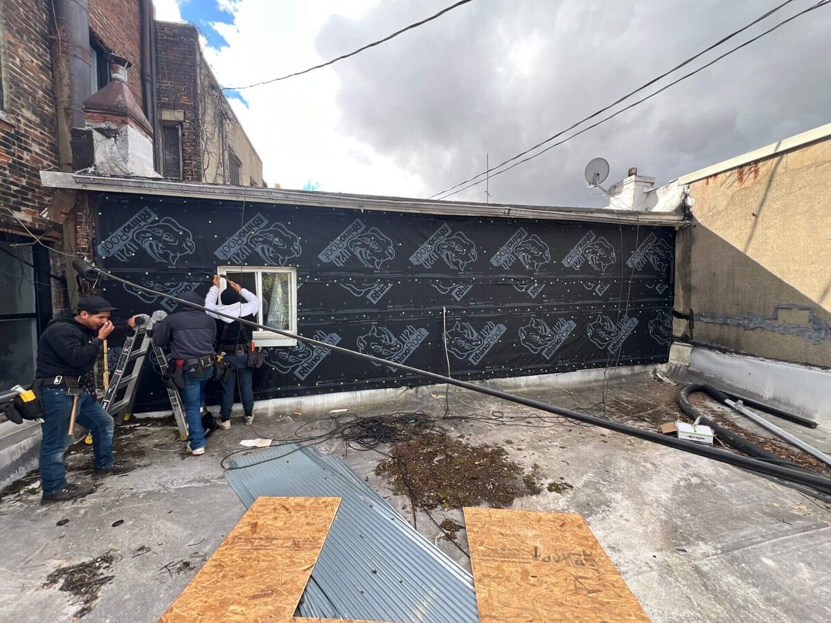 Black Bear Roofing crew preparing a commercial roof for installation.