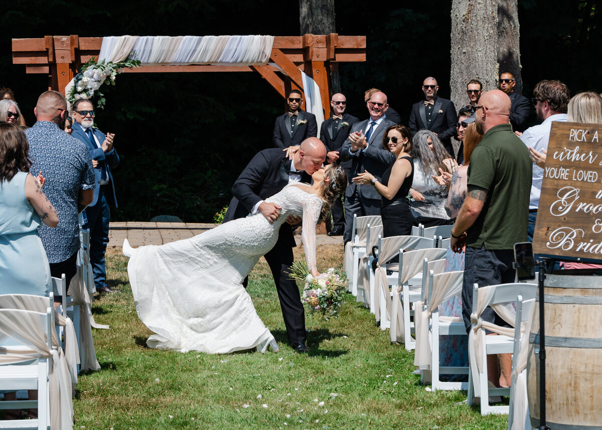 just married kiss groom dips bride in aisle