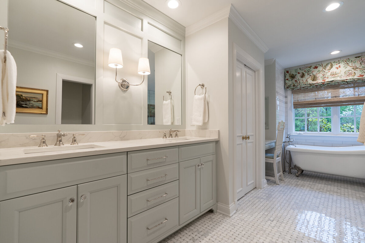 light gray cabinets in a bathroom with white and silver accents