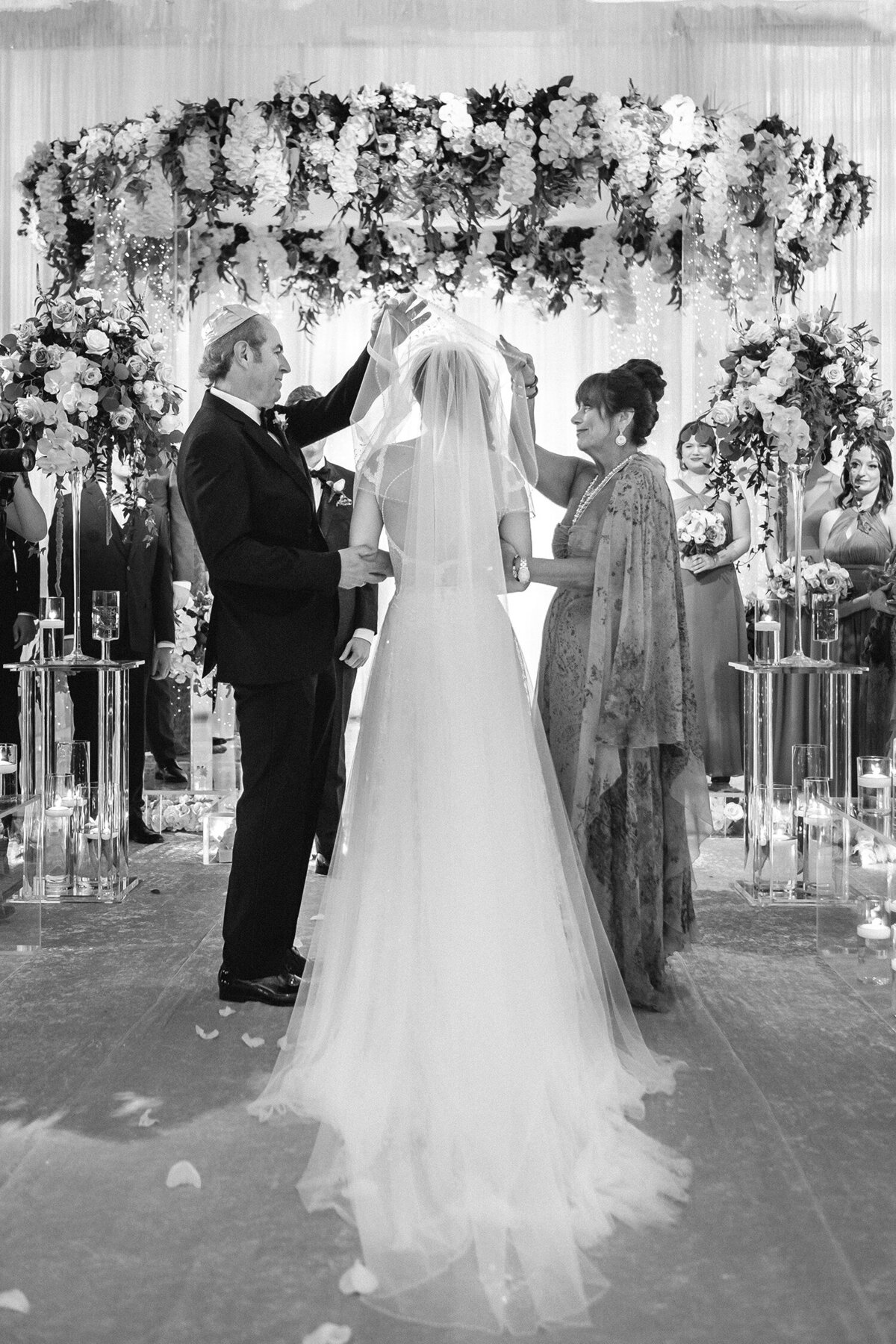 Black and white photo of the bride with her parents about to walk down the aisle for the wedding ceremony