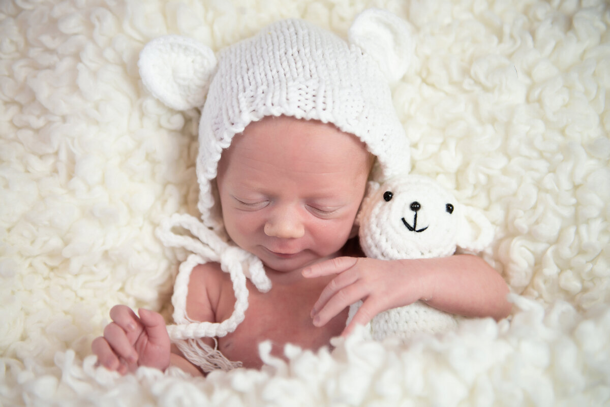Newborn baby in bear hat with teddy bear in Kennebunk Maine