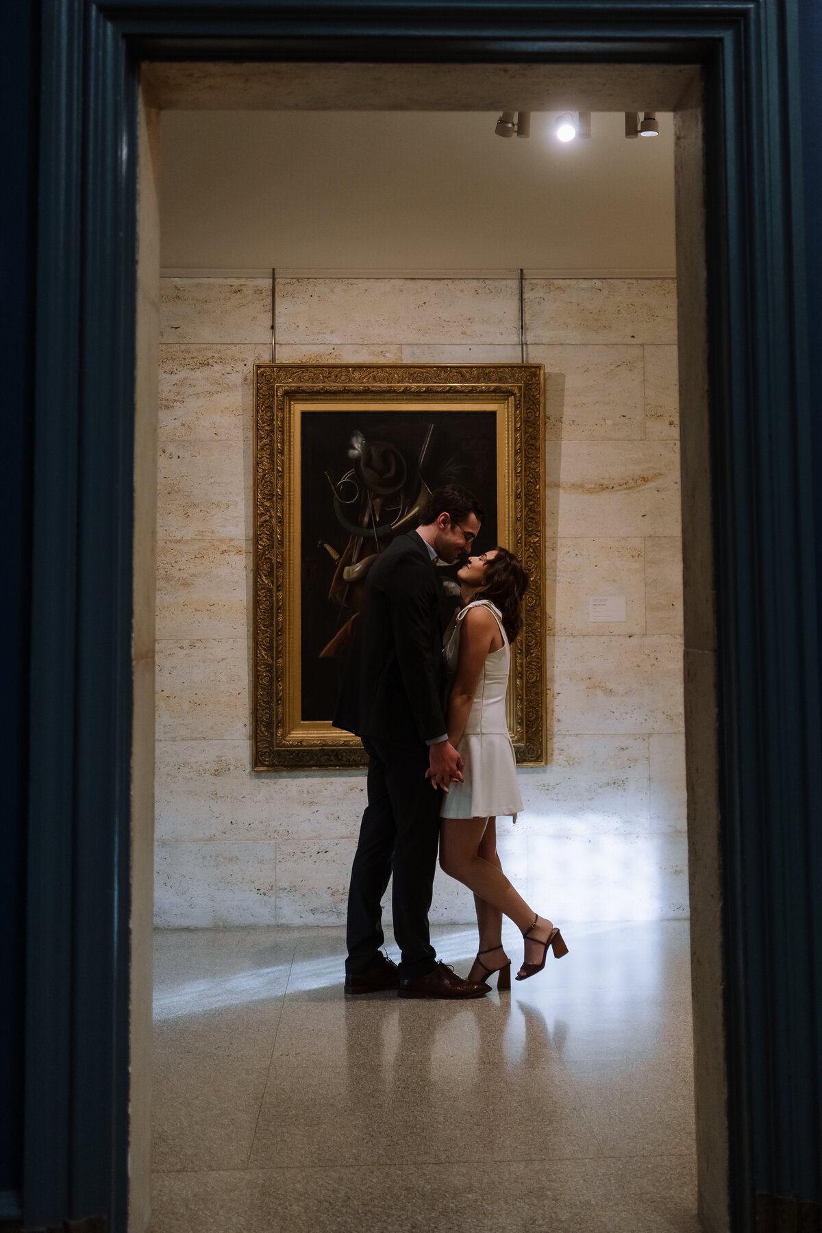 happy couple focused on each other, in art gallery