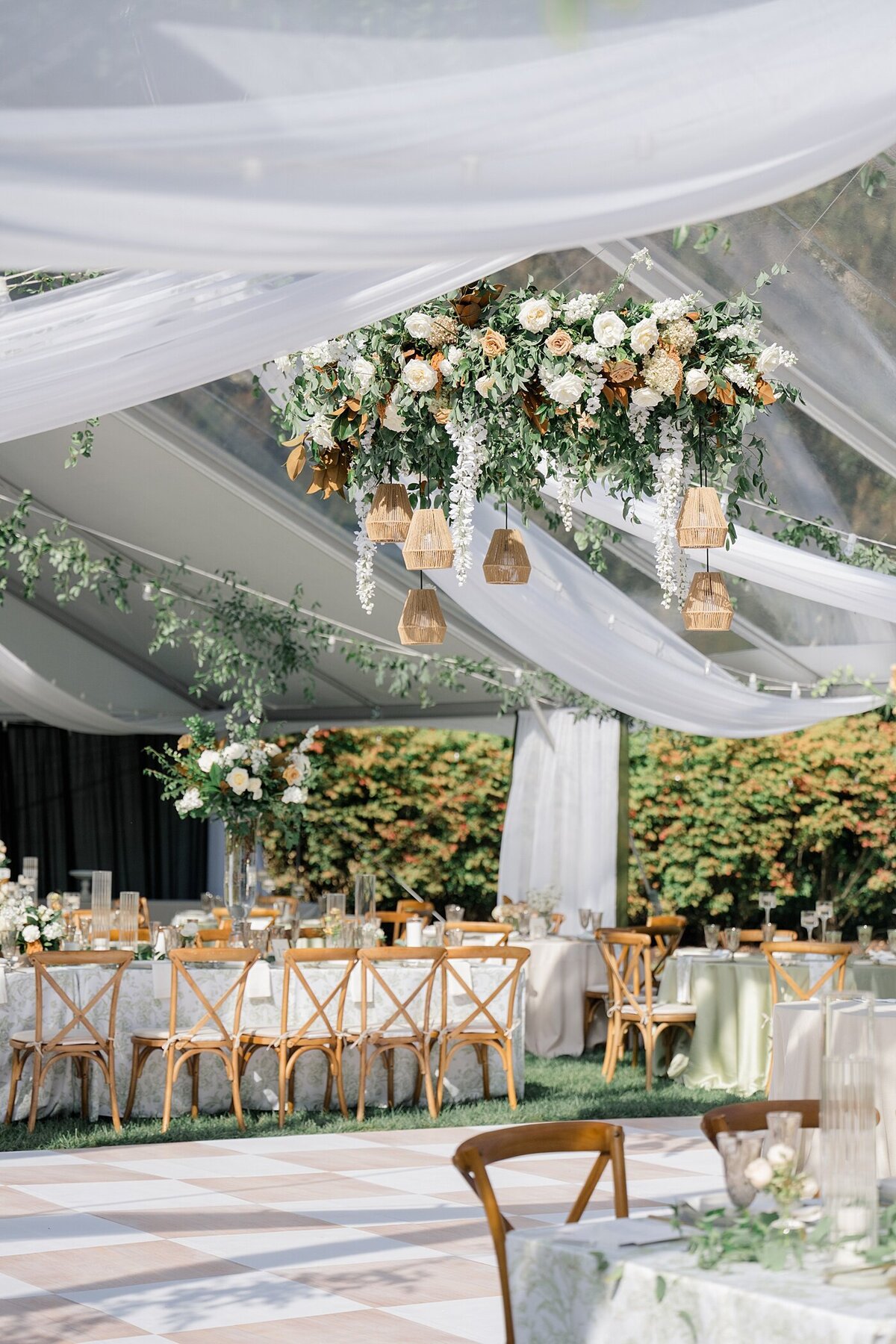 outdoor wedding decor in a white tent with wood chairs and pink florals for Columbus wedding venues